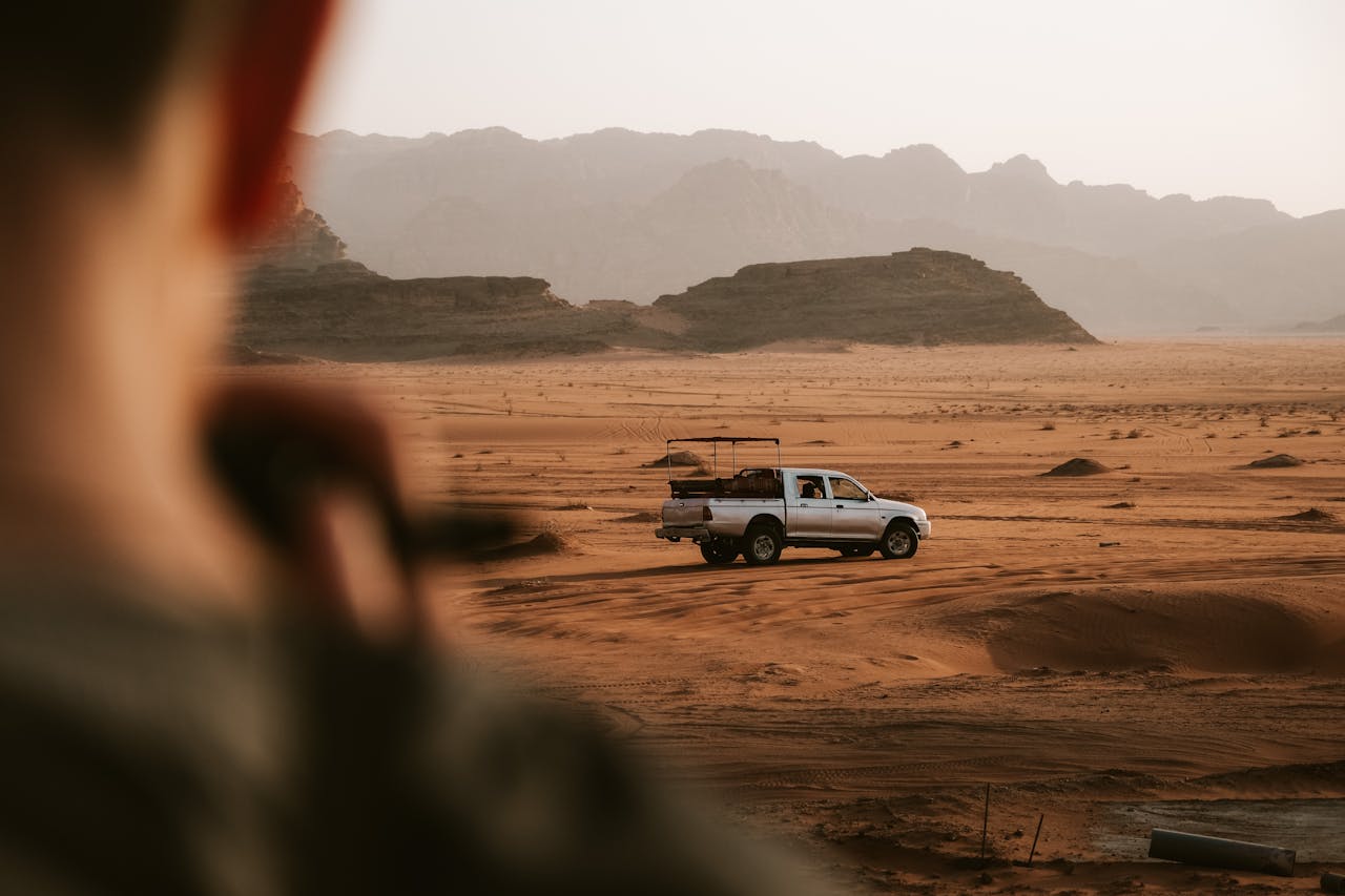 A scenic off-road vehicle journey through the beautiful Wadi Rum desert with stunning sandstone landscapes.